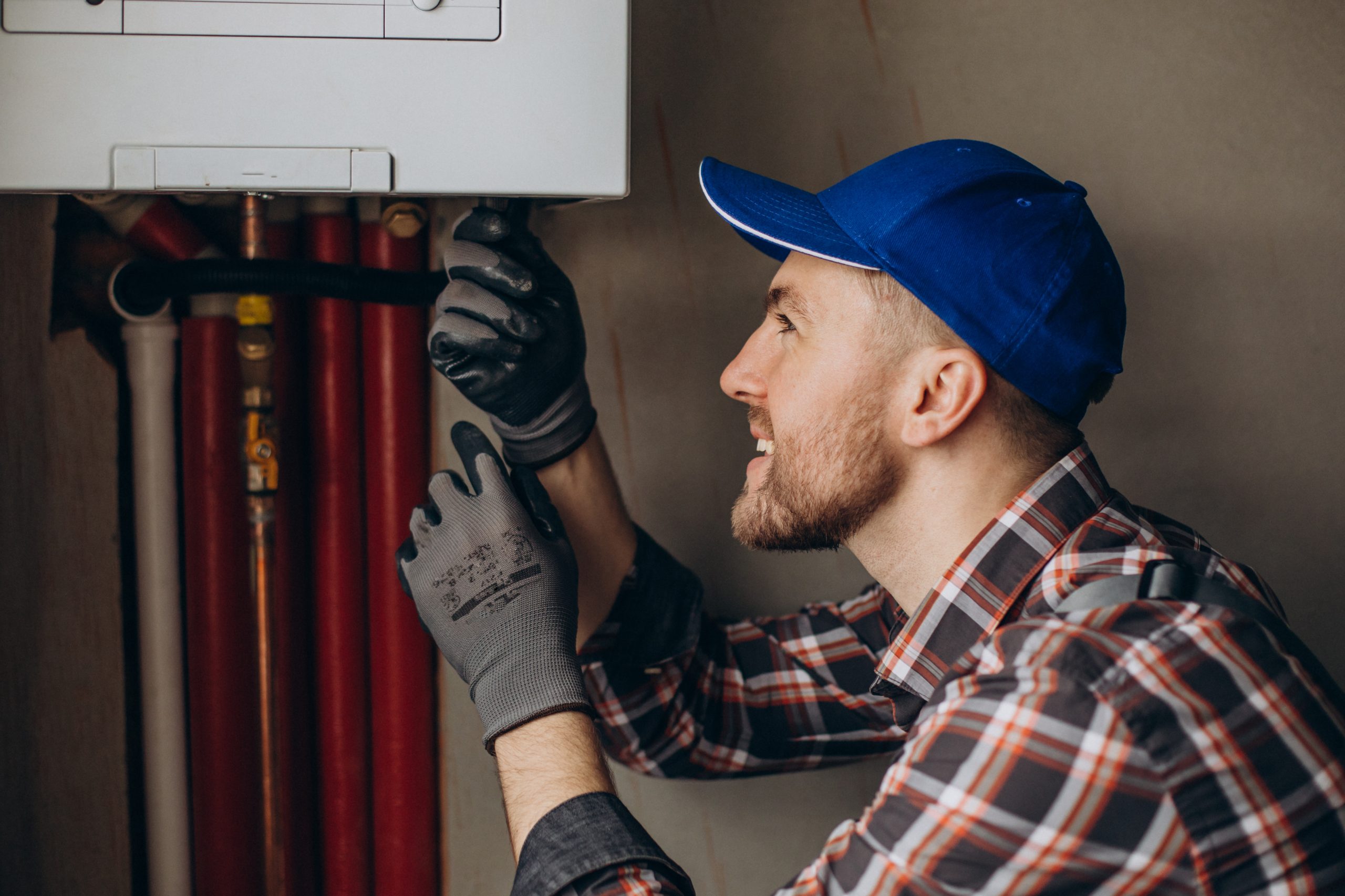 service man adjusting house heating system scaled